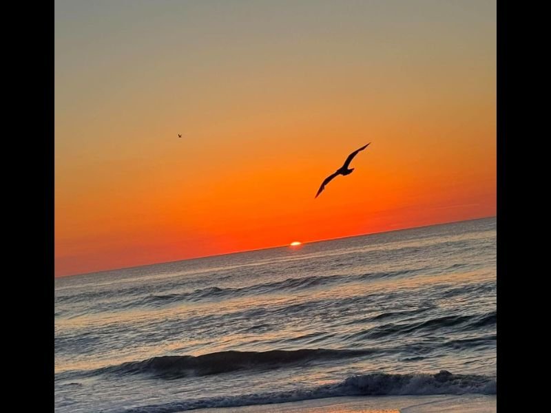Stunning Fiery Red and Orange Sunrise Captured Over Ocean at Kure Beach New Hanover County North Carolina This Morning